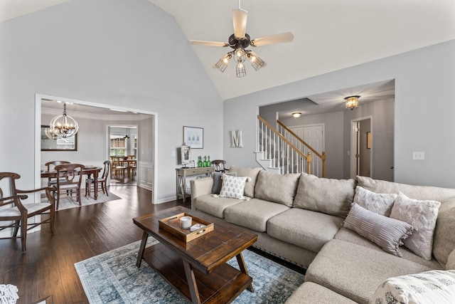 living room featuring ceiling fan with notable chandelier, high vaulted ceiling, dark wood-type flooring, and stairs