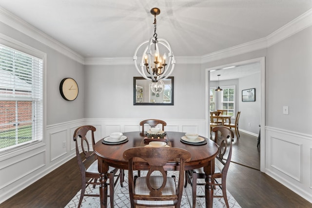 dining space with a chandelier, dark wood-style flooring, and wainscoting