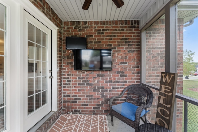 unfurnished sunroom featuring ceiling fan