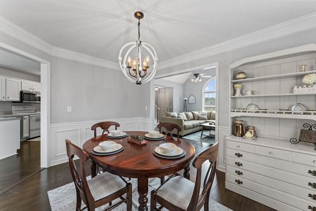 dining room with dark wood-type flooring, ceiling fan with notable chandelier, and crown molding