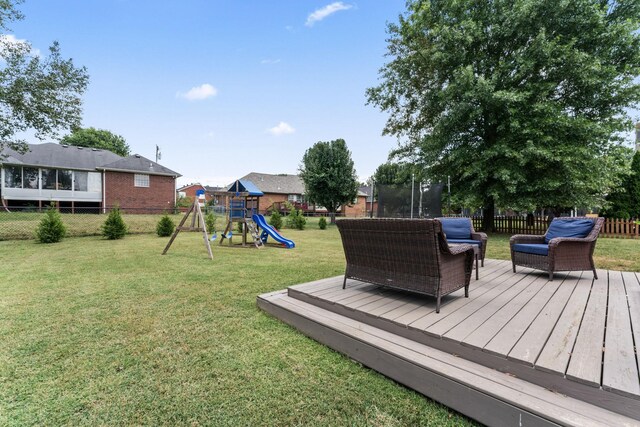 exterior space featuring a wooden deck and a playground