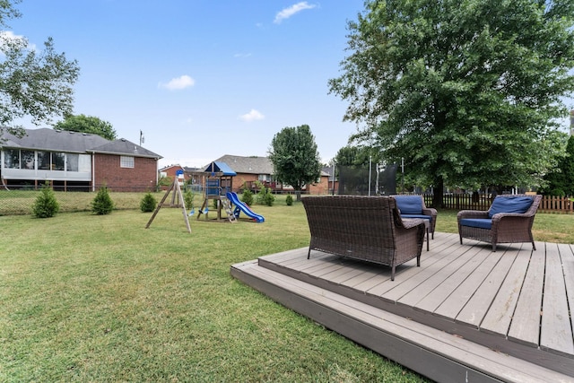 wooden deck featuring a yard, a trampoline, a playground, and fence