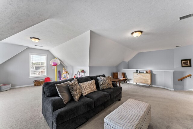 living room with carpet flooring, a textured ceiling, and lofted ceiling