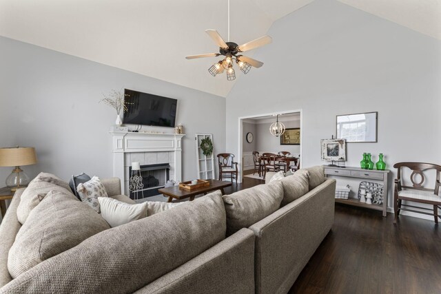 living room featuring a fireplace, ceiling fan with notable chandelier, high vaulted ceiling, and dark hardwood / wood-style floors