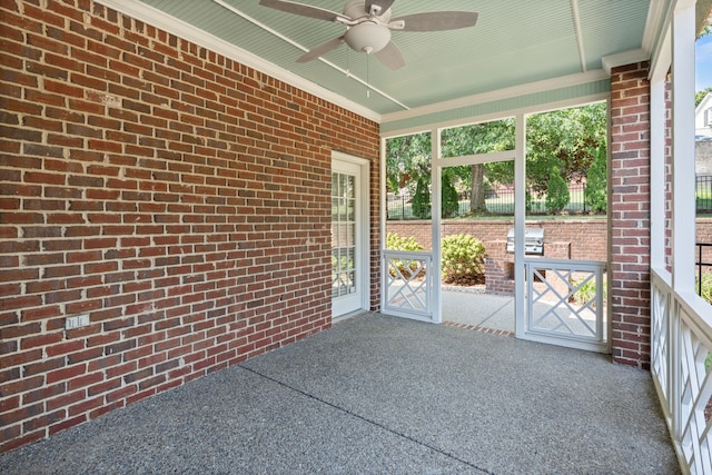 unfurnished sunroom featuring a wealth of natural light and ceiling fan