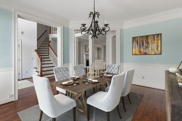 dining space featuring crown molding, an inviting chandelier, and dark hardwood / wood-style flooring