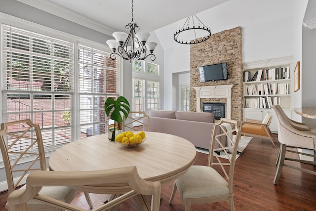 dining area with a fireplace, a notable chandelier, dark wood-type flooring, and built in features