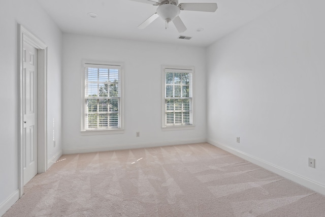 carpeted empty room featuring ceiling fan