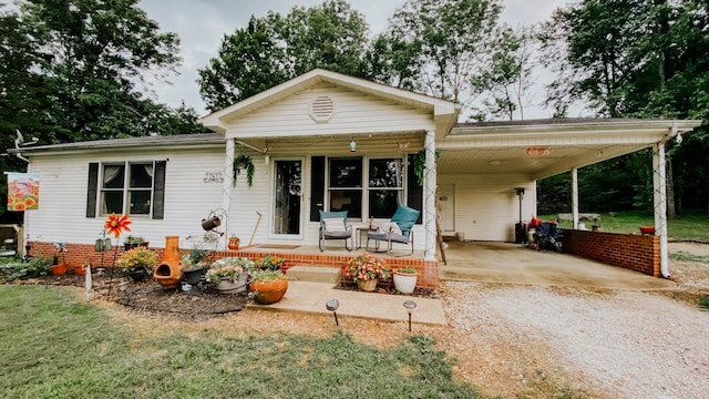 bungalow-style house with a carport and a front yard