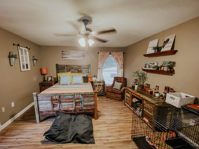 bedroom with ceiling fan and light hardwood / wood-style flooring