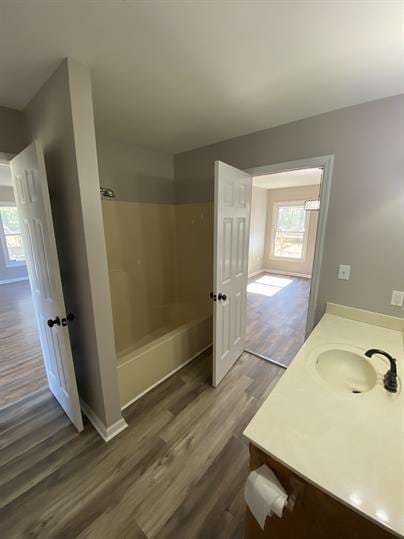 full bath with vanity, shower / bathing tub combination, baseboards, and wood finished floors