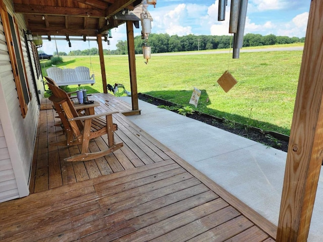 wooden terrace featuring a yard