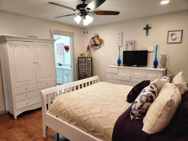 bedroom with ceiling fan, dark hardwood / wood-style floors, and a closet