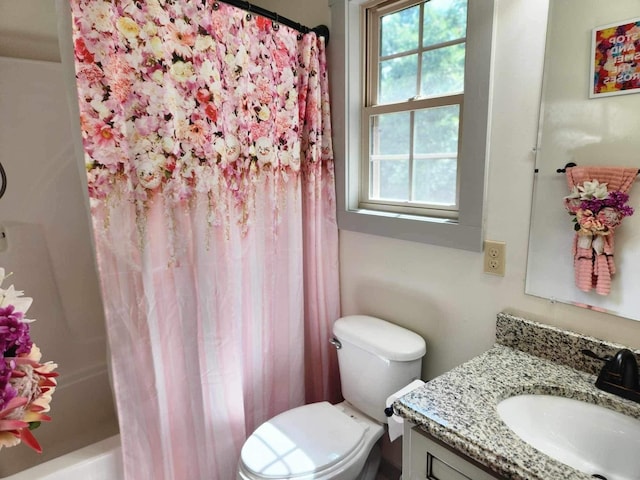 bathroom with toilet, shower / tub combo, and vanity