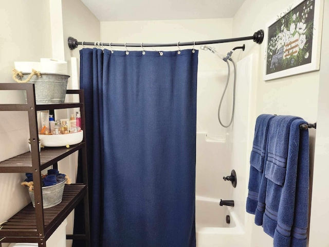 bathroom with shower / bath combo with shower curtain