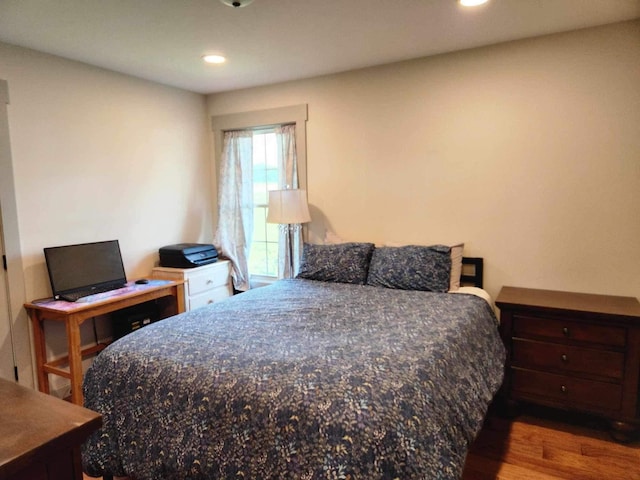 bedroom with wood finished floors and recessed lighting