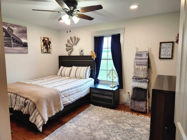 bedroom with ceiling fan and dark hardwood / wood-style floors