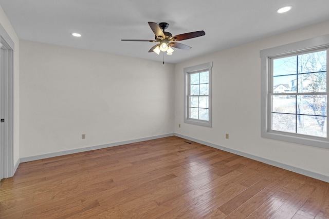 unfurnished room with ceiling fan and light hardwood / wood-style floors