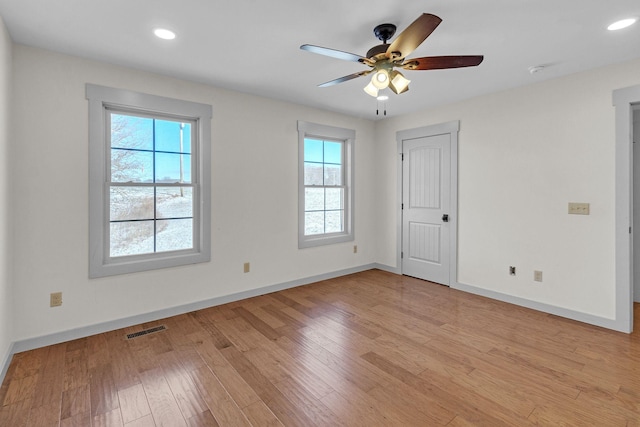 unfurnished room featuring light hardwood / wood-style floors, a wealth of natural light, and ceiling fan