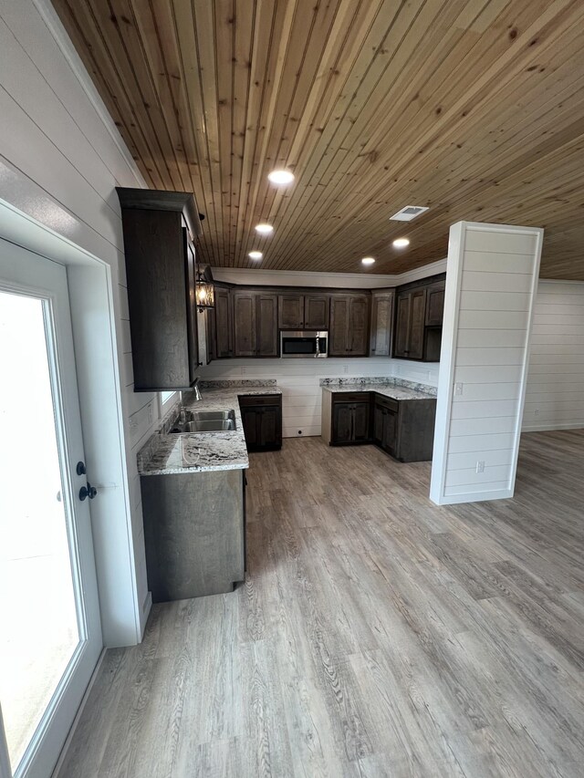 kitchen with light hardwood / wood-style floors, sink, dark brown cabinetry, and wooden ceiling