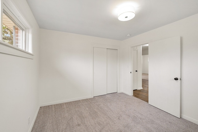 unfurnished bedroom featuring carpet floors and a closet