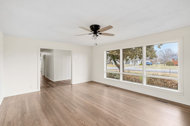 spare room with ceiling fan and wood-type flooring