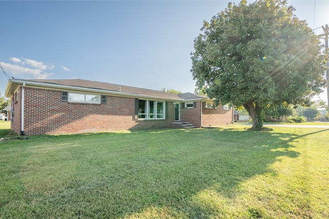 back of property featuring a lawn