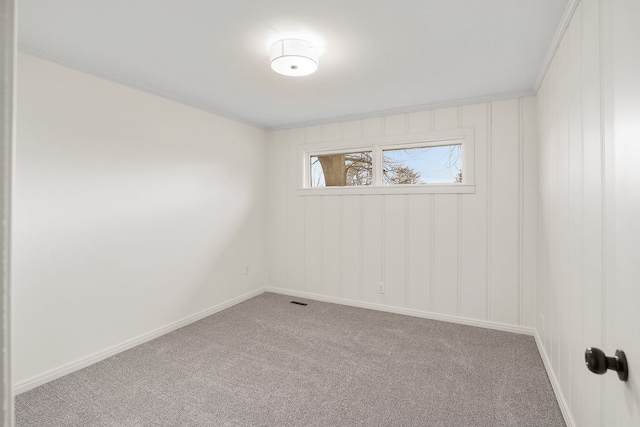 carpeted spare room featuring ornamental molding