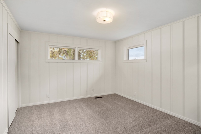 interior space featuring multiple windows and carpet floors