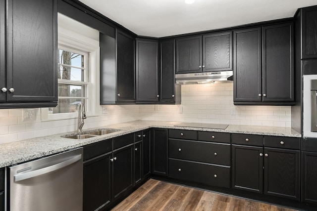 kitchen with decorative backsplash, dark hardwood / wood-style flooring, dishwasher, light stone countertops, and sink