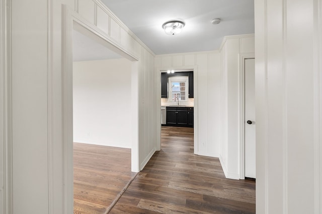 corridor featuring dark hardwood / wood-style floors and sink