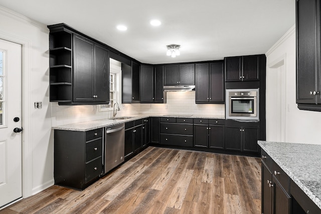 kitchen featuring sink, stainless steel appliances, dark hardwood / wood-style flooring, and backsplash