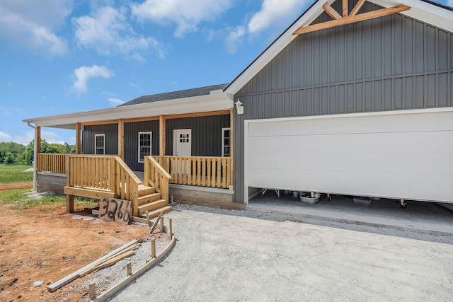 view of front facade featuring covered porch and a garage