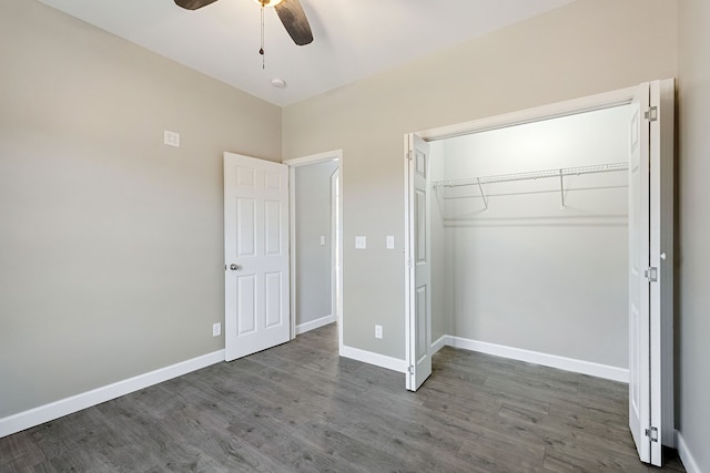 unfurnished bedroom with dark hardwood / wood-style floors, a closet, and ceiling fan