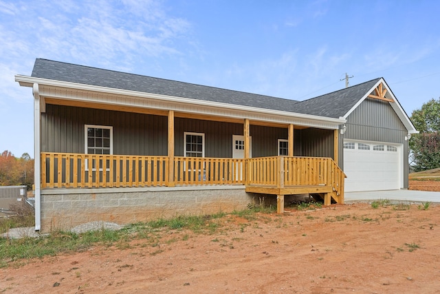 ranch-style home with a garage and a porch