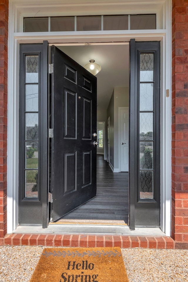 doorway to property with brick siding