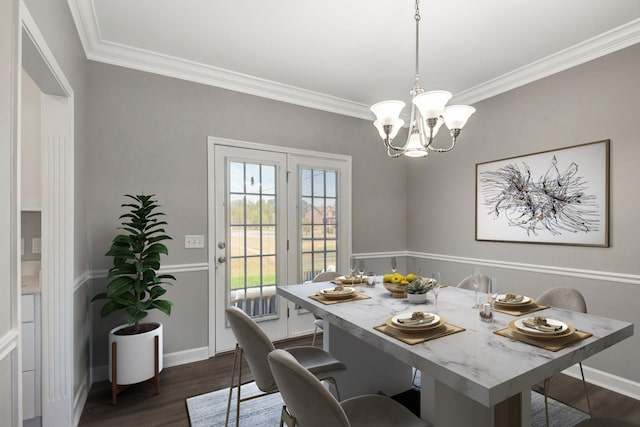 dining area featuring crown molding, baseboards, dark wood-style flooring, and a chandelier