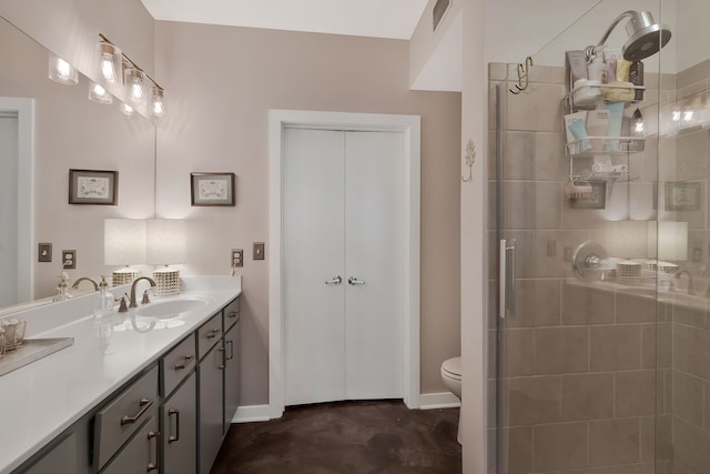 bathroom with toilet, an enclosed shower, and vanity