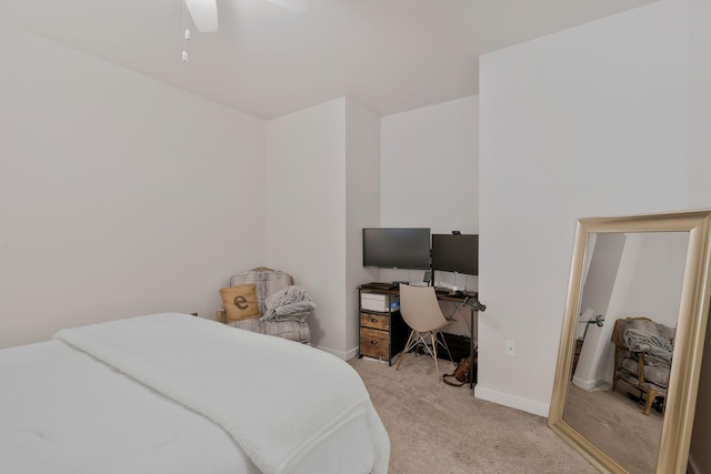 bedroom with light carpet, ceiling fan, and baseboards