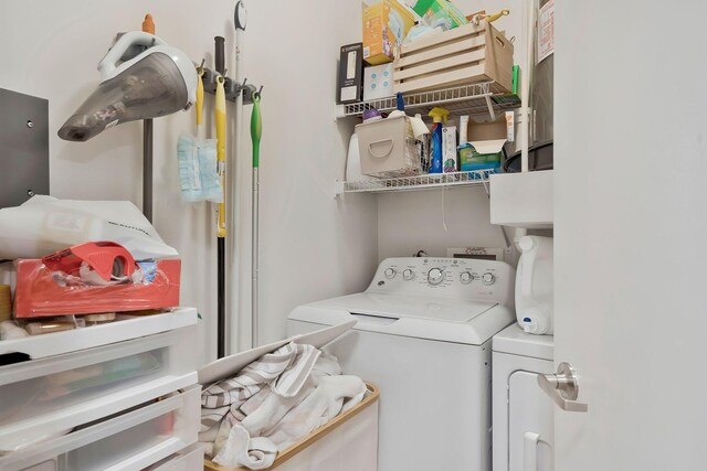 clothes washing area featuring independent washer and dryer