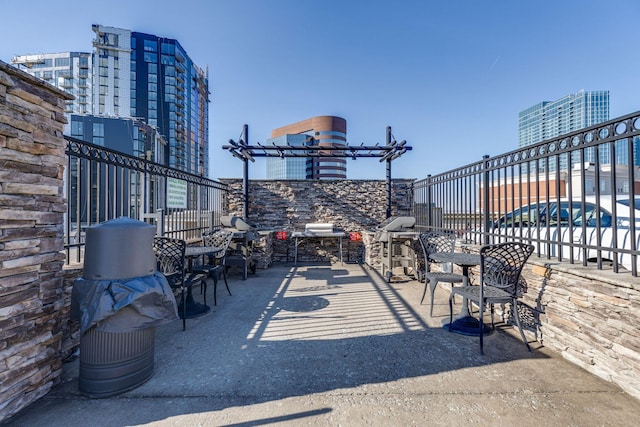 view of patio / terrace featuring a view of city and area for grilling