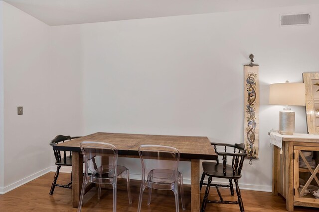 dining space with hardwood / wood-style floors