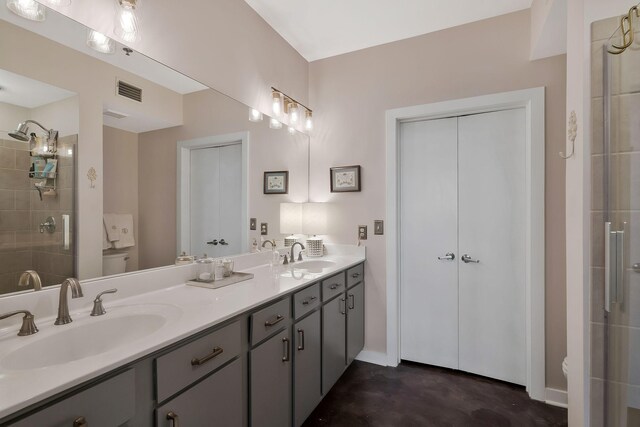 bathroom featuring concrete flooring, toilet, an enclosed shower, and vanity