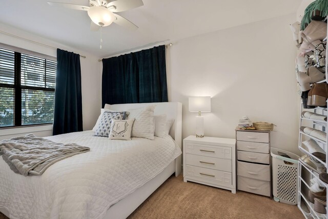 bedroom featuring light colored carpet and ceiling fan