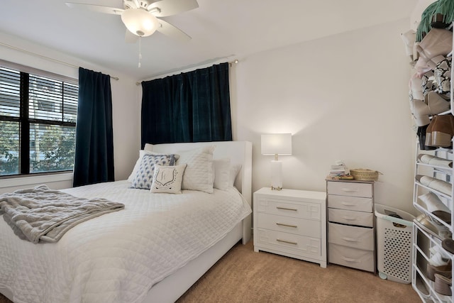 bedroom featuring a ceiling fan and light colored carpet