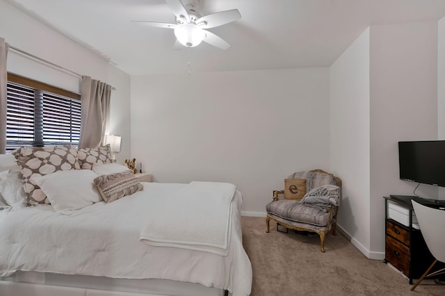 bedroom featuring light colored carpet, ceiling fan, and baseboards