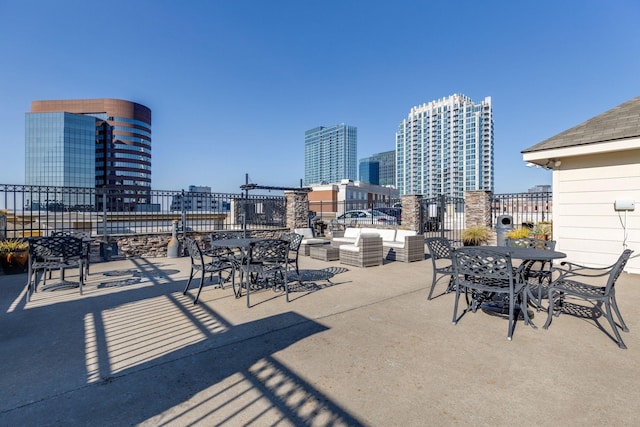 view of patio featuring outdoor dining area and a city view