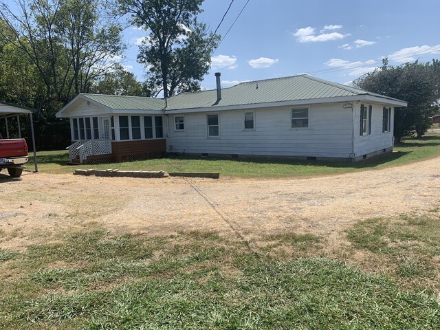 back of house with a lawn