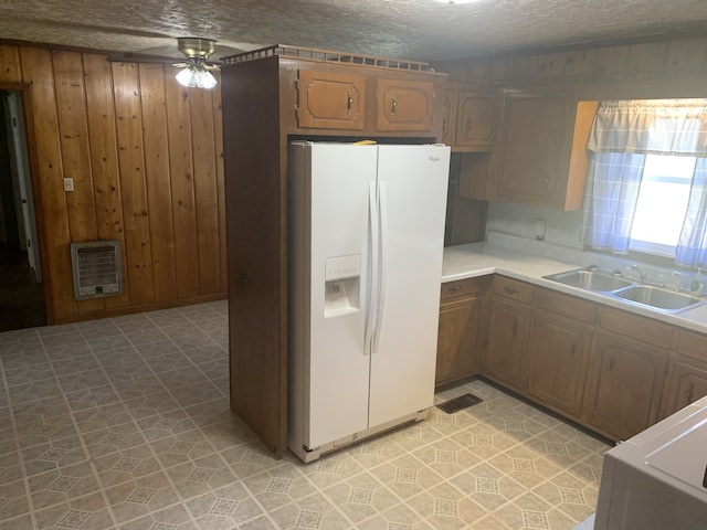 kitchen featuring ceiling fan, white refrigerator with ice dispenser, sink, a textured ceiling, and light tile patterned flooring