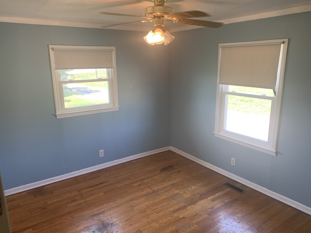 spare room featuring ceiling fan, a healthy amount of sunlight, and hardwood / wood-style floors